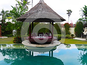 Shaded area near an infinity pool with towel swans