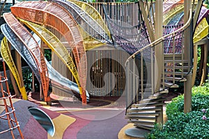 Shaded kid`s playground activity tower equipment at park. Children`s playing area indoor with toys equipment