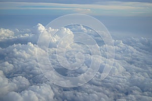 Shades of light blue color sky and constantly change floating white cloud heaven view from airplane window