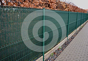 the shading fabric on the wire fence creates a private space and in