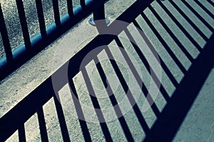 Shadow of the bars of a railing on a street in Madrid, Spain.