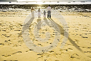 Shadow on beach of family look to sea in wedding day.foot print