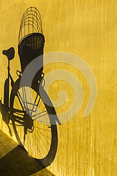 Shadow from bicycle on concrete wall vertical