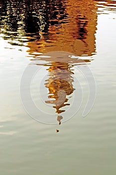 Shadow of Buddha statue in water