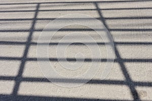 The shadow of car grille apper on the street