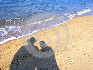 Shadow of couple on beach