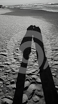 The shadow of a couple on the beach