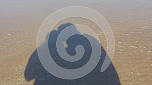 Shadow of a couple on the beach