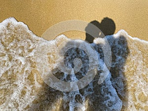 Shadow of a couple on the sand