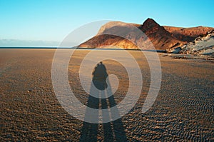 The shadow of a couple at sunset at Qalansia beach, love, honeymoon, Socotra, Yemen