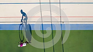 Shadow of a cyclist training at a velodrome. preparation for professional competitions. Original creative shape top view photo