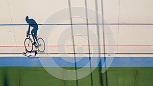 Shadow of a cyclist training at a velodrome. preparation for professional competitions. Original shape top view photo