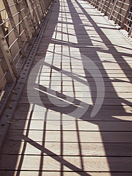 Shadow of The Evan Walker footbridge handrailing photo