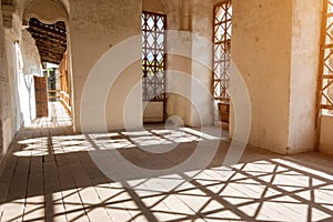 The shadow falls from the window grilles in the castle