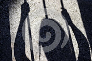 Shadow of female prisoner inside a prison cell projected on the ground.