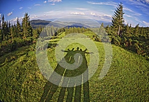 Shadow of friends among fantastically beautiful scenery on the background of the Carpathian mountains