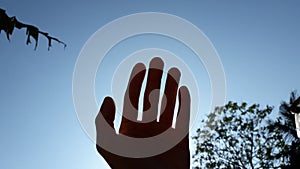 The shadow of hand under the sky