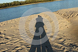 Shadow of hugging lovers on the beach
