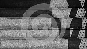 The shadow of the iron railing on the concrete stairs. - monochrome