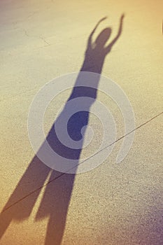 Shadow of a kid playing in the street
