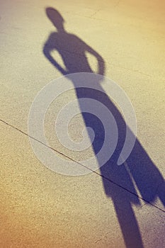 Shadow of a kid playing in the street