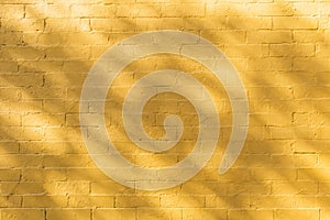 Shadow and light on yellow brick wall background texture