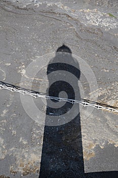 Shadow of the Lighthouse of Ponta dos Capelinhos on the volcanic lavacoast from 1957-58 eruption photo