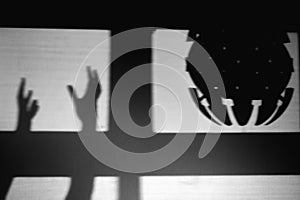 A shadow like an alien spaceship, monochrome. Kidnapping and UFO silhouette in the window, black and white concept