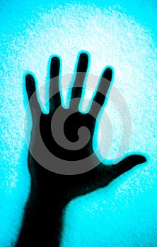 shadow of man hand on blue background