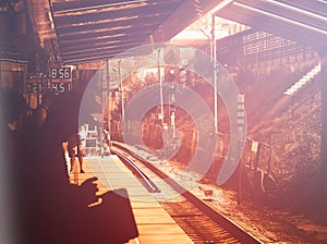 Shadow of man on train station during sunset