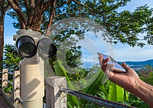 shadow from hand with mobile on the reflector