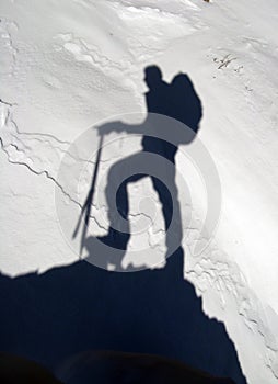 Shadow of a mountain climber on snow