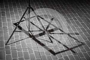 Shadow of Note stand on the floor