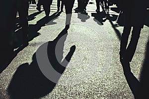 Shadow of the people on the asphalt crossing the street