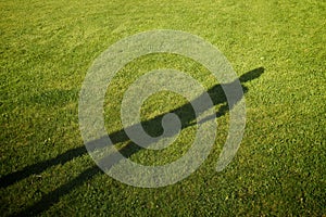 Shadow on a perfectly-mown meadow