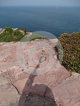 Shadow of photographer touches a pile of stones