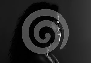 In The Shadow. Profile Of Black Attractive Female Over Dark Background, BW