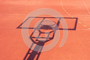 Shadow of the rack with a shield and basketball ring during sunny day outdoors. Basketball game background