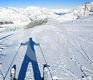 A shadow of ready to go downhill skier
