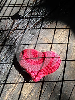 Red heart under grid pattern shadow