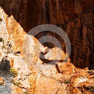 Shadow of a rock climber, climbing on the mountain