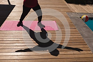 Shadow of a senior woman performing stretching exercise