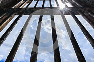 Shadow shining through the bars of the old prison