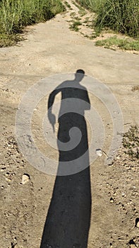 Shadow silhouette of cowboy with hat and gun in his hand