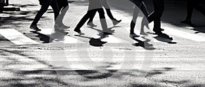 Shadow silhouette of a pedestrians crossing city street