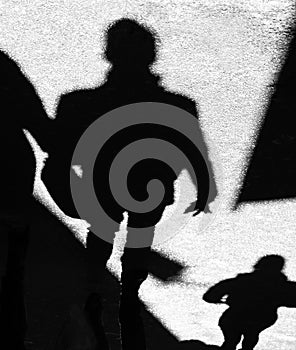 Shadow silhouette of unrecognizable people walking city street