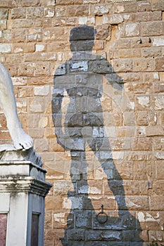 Shadow of statue of David by Michelangelo on Palazzo Vecchio of Florence. Piazza della Signoria, Tuscany region of Italy