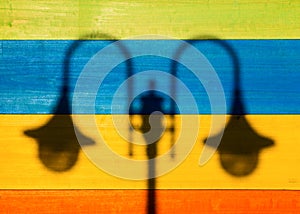 Shadow of Street Lamps on Colored Wooden Background