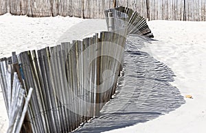 The shadow thrown by a fence on the beach
