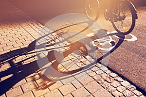 Shadow of unrecognizable cyclist on bicycle lane